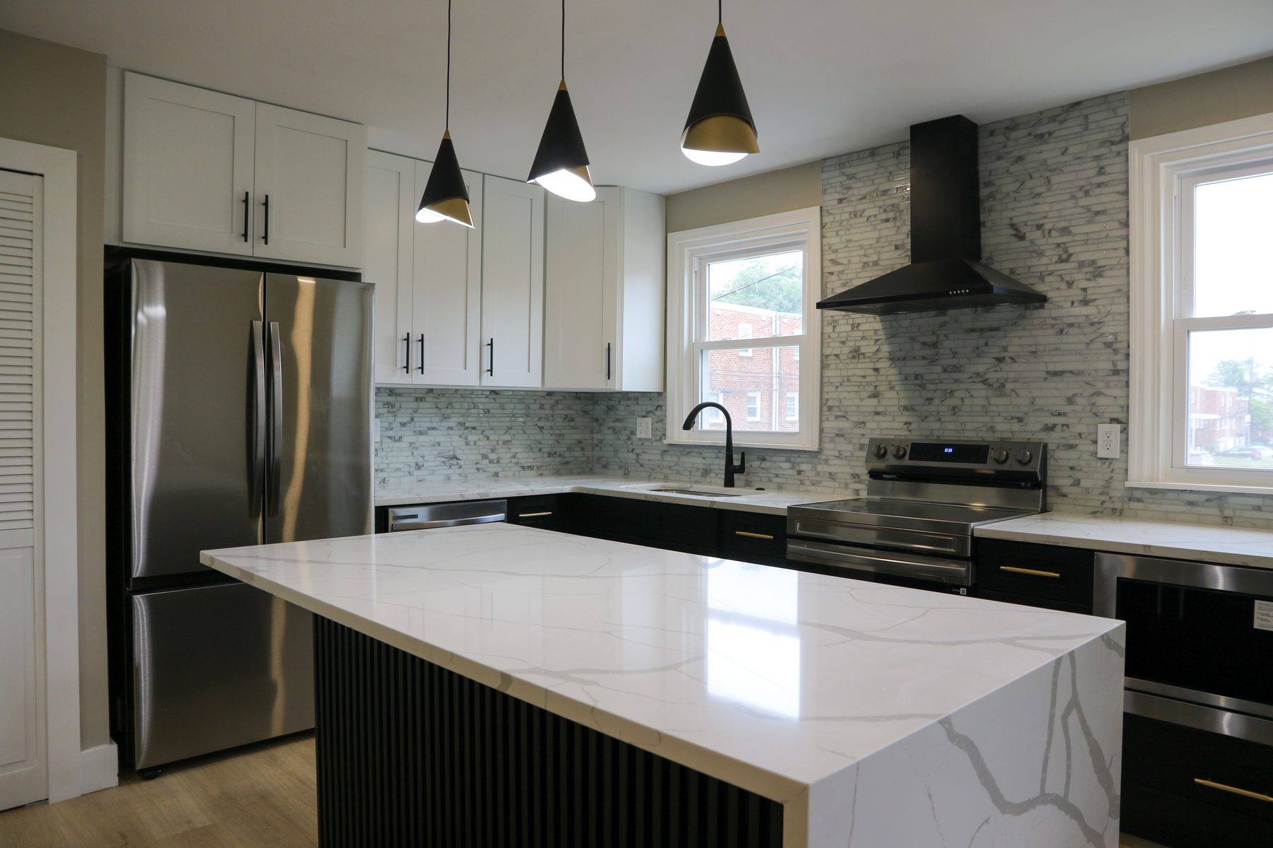 Recent UMG kitchen project featuring stone countertops and custom cabinetry