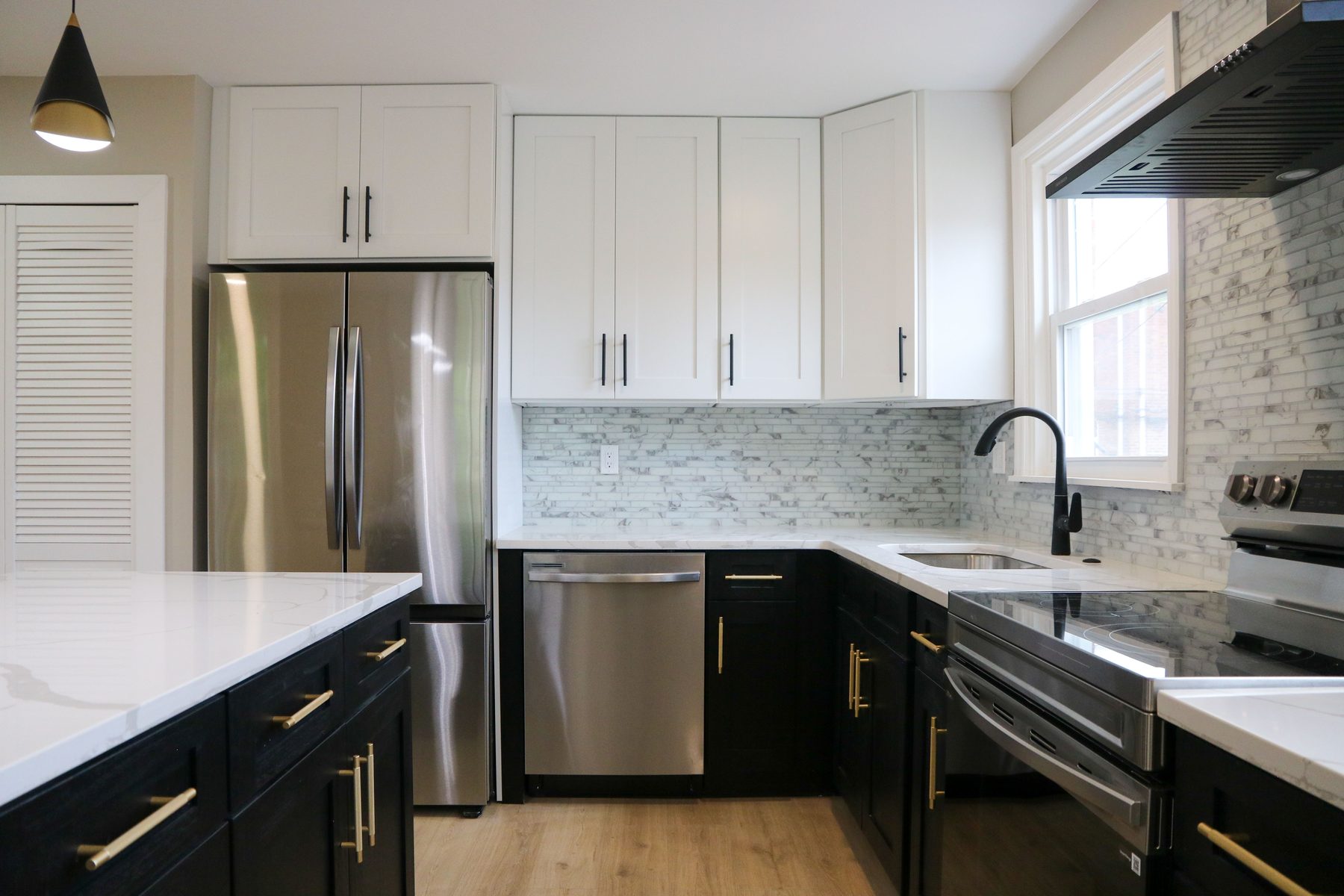 Completed kitchen remodel with full-height stone backsplash