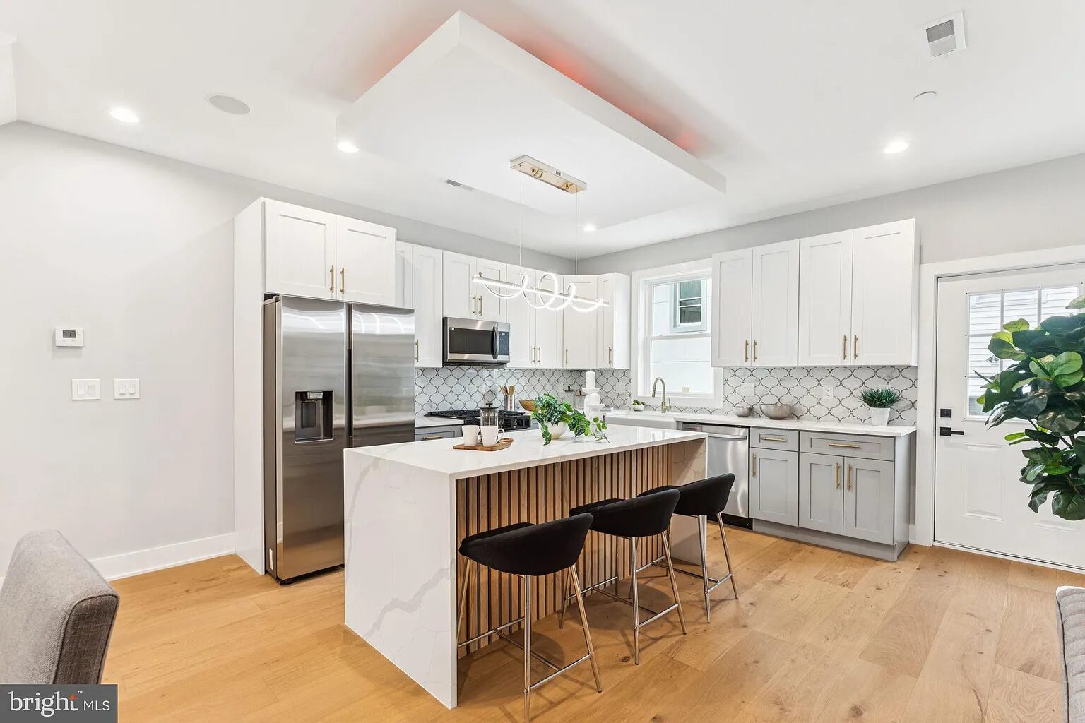 Finished kitchen project with light cabinetry and granite counters