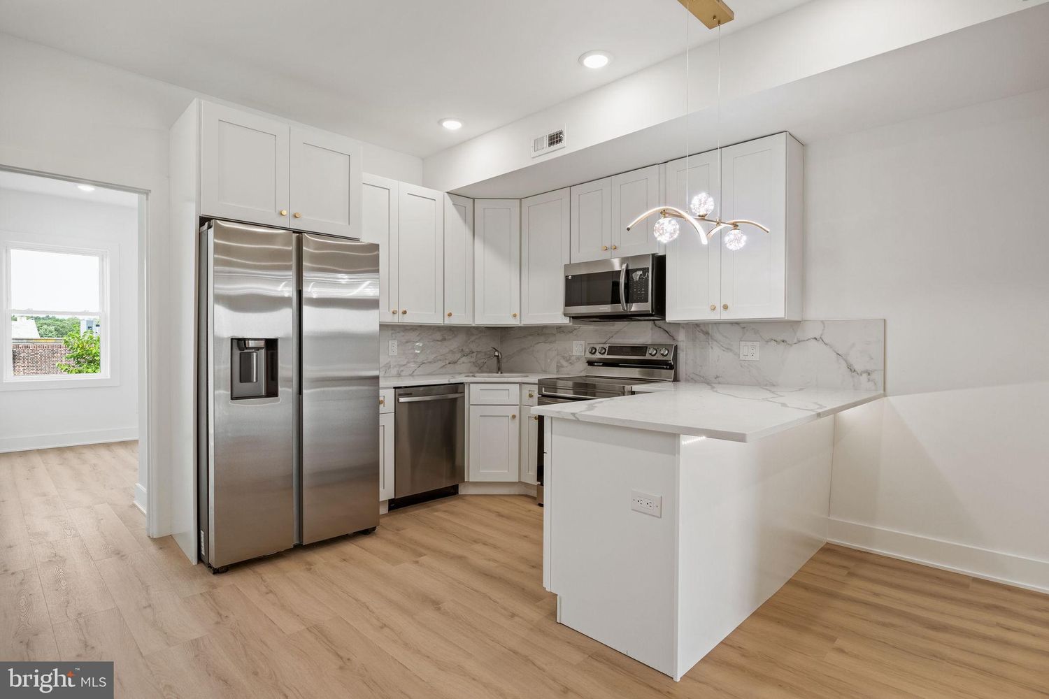 Kitchen remodel featuring farmhouse sink and subway tile