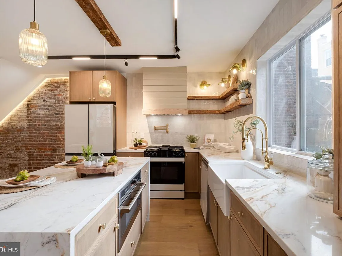 Stacked stone backsplash behind a gas range