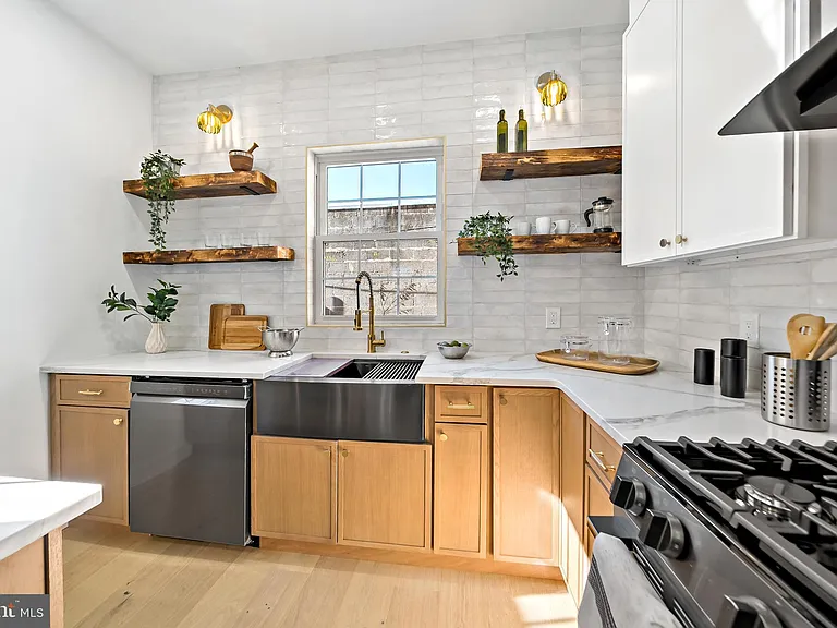 White kitchen with granite backsplash and pantry cabinets
