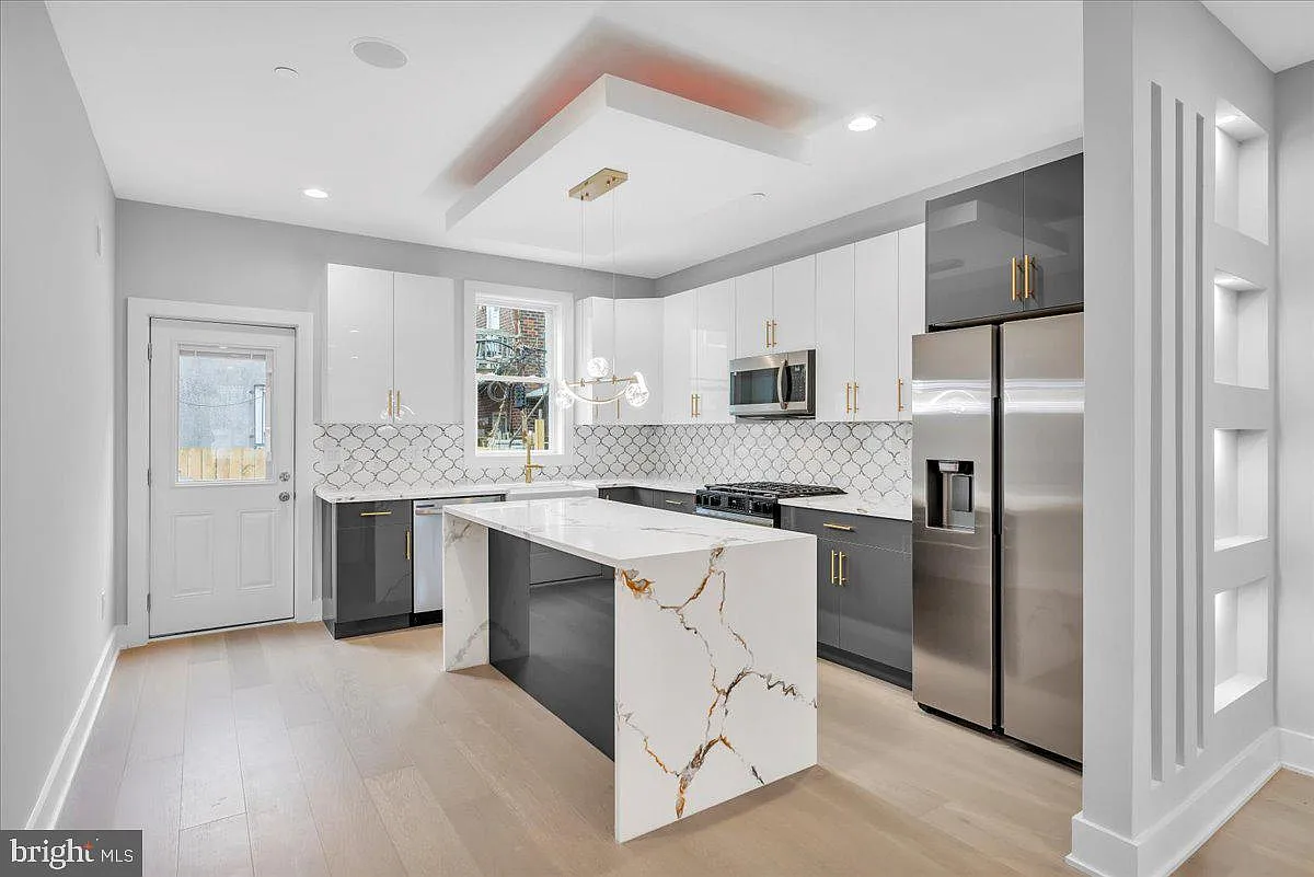 Quartz kitchen island with pendant lighting and bar seating