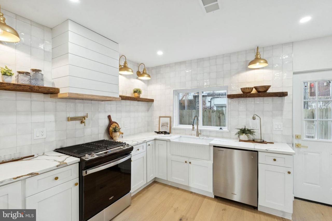 Custom kitchen project featuring full-height stone backsplash