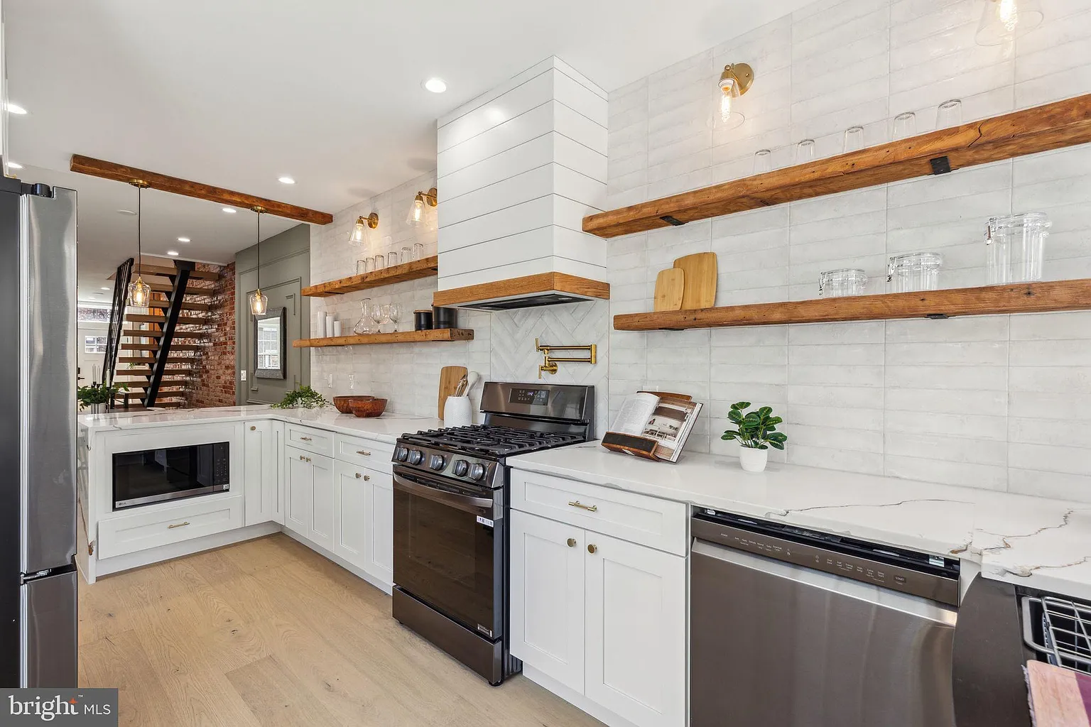 Bathroom remodel featuring a floating vanity and quartz top