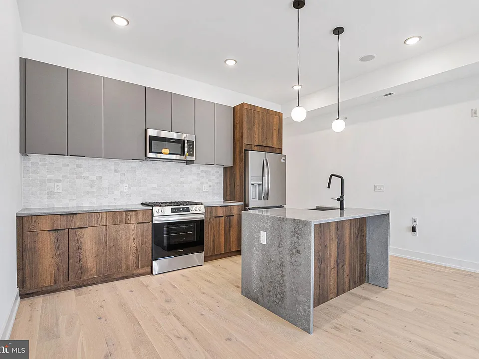 Completed kitchen install with stainless steel appliances