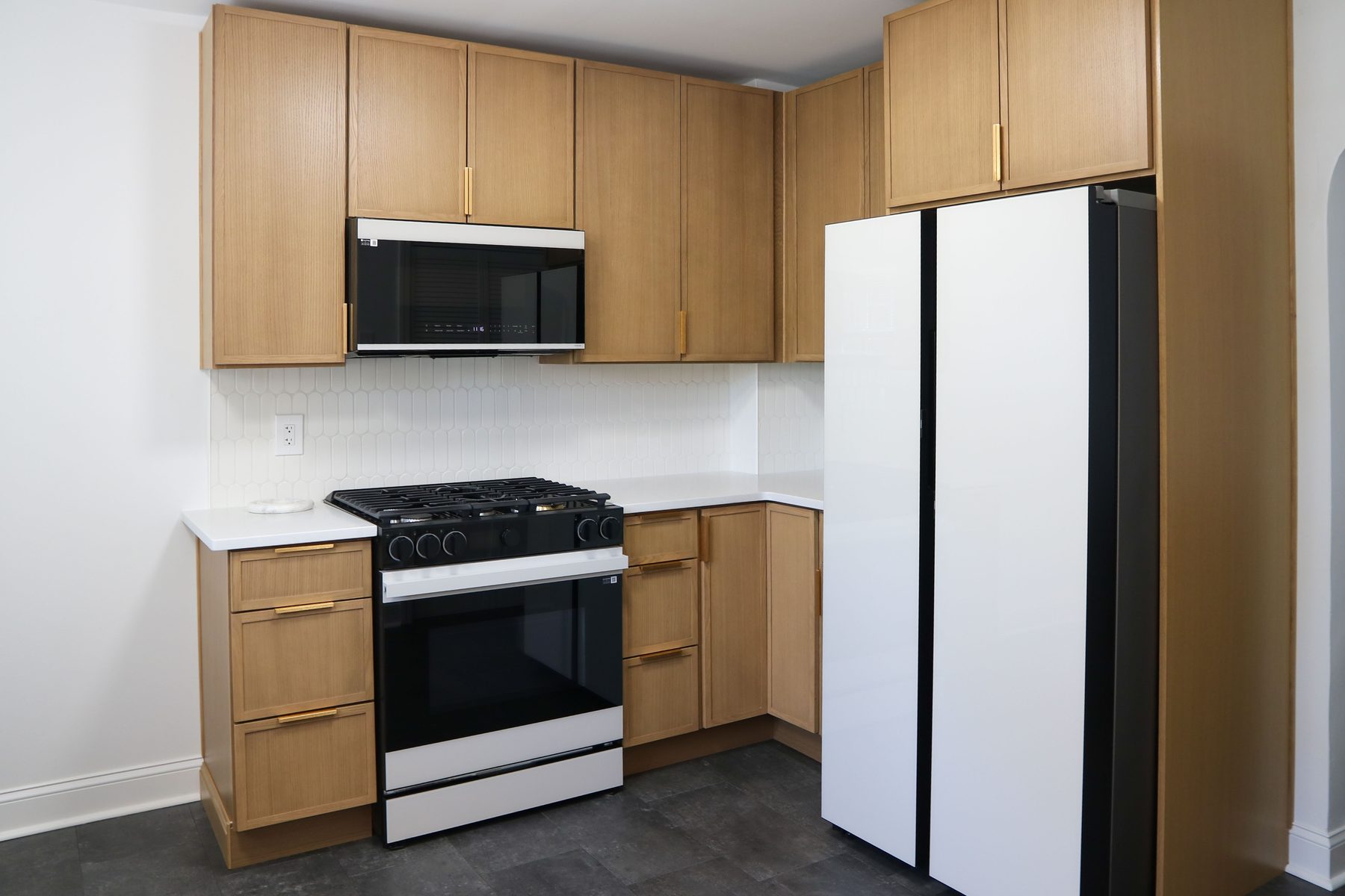 Detailed view of cabinetry, hardware, and stone counter finish