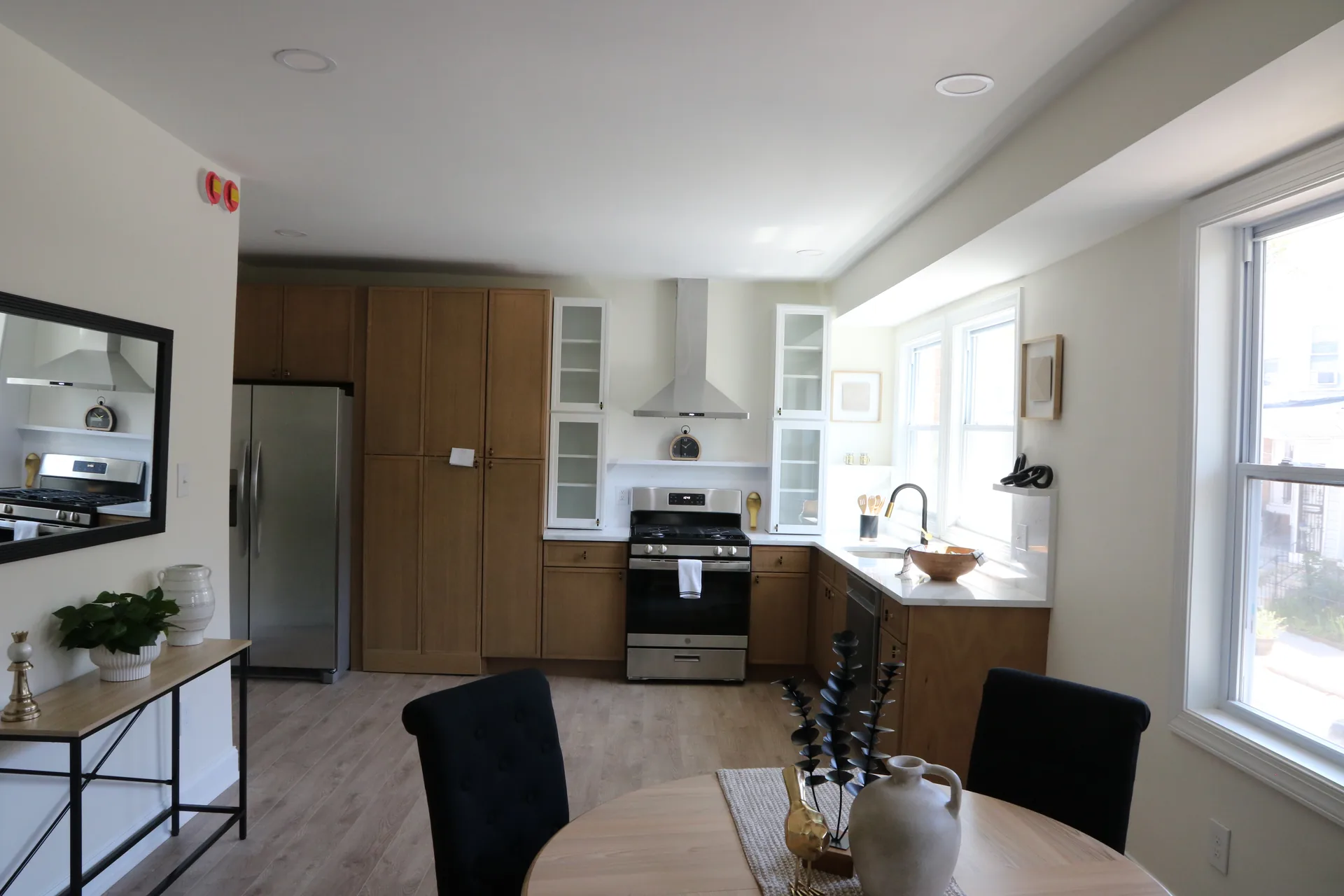 Open kitchen and dining space with wood cabinets and stainless fridge
