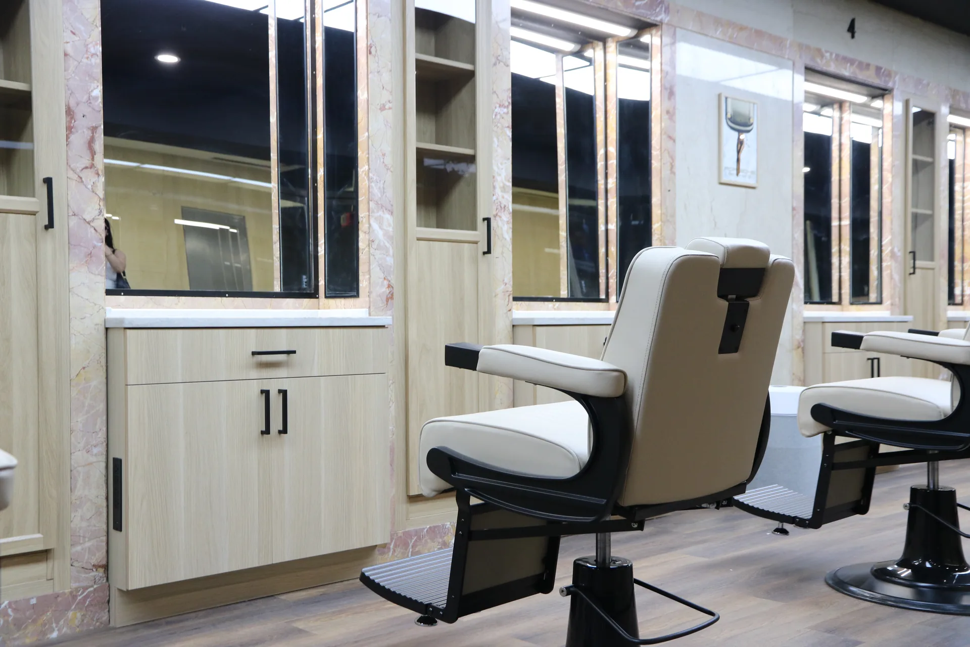 Commercial barbershop build-out with custom marble-framed stations
