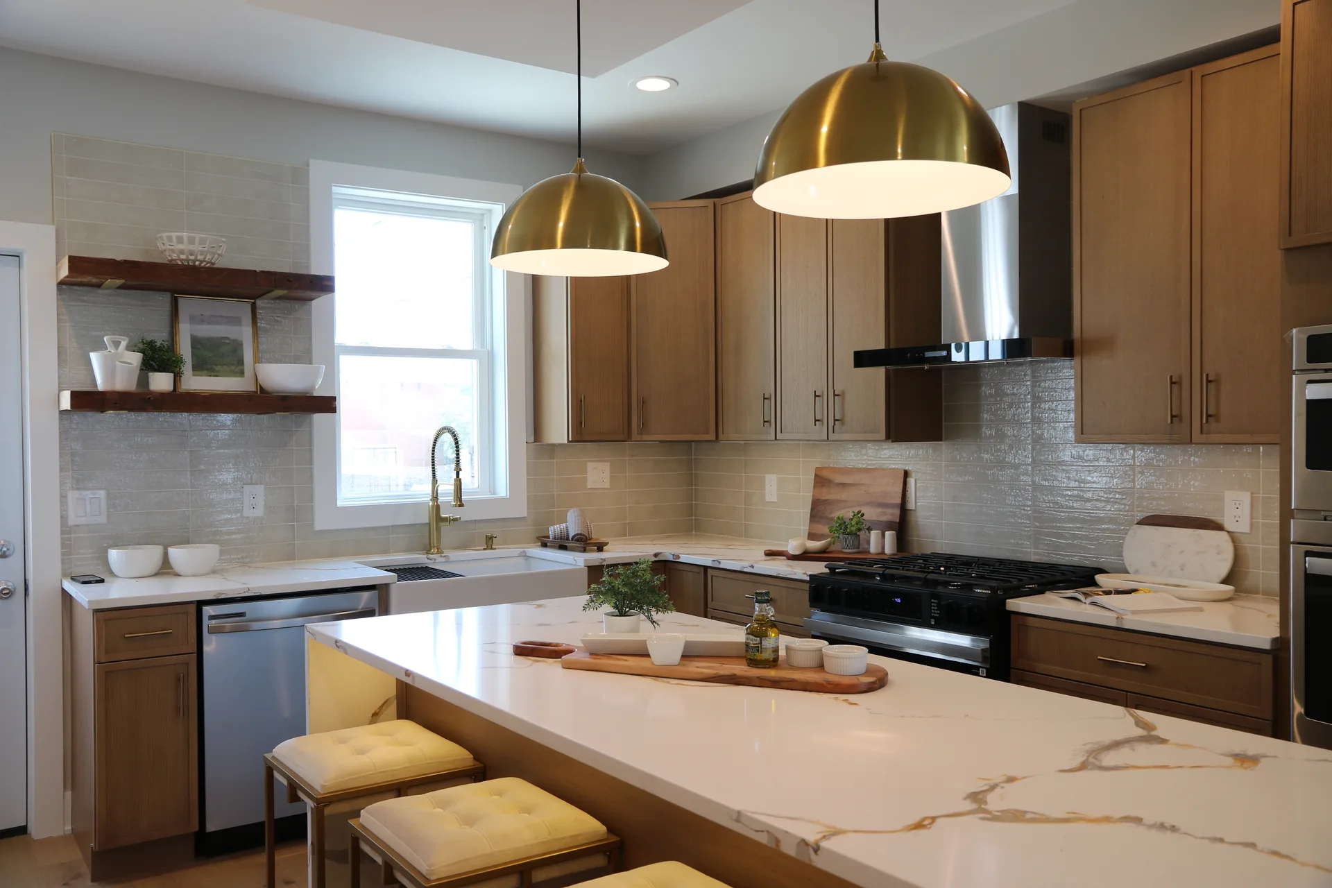 Full kitchen with white oak cabinets, farmhouse sink, and waterfall quartz island