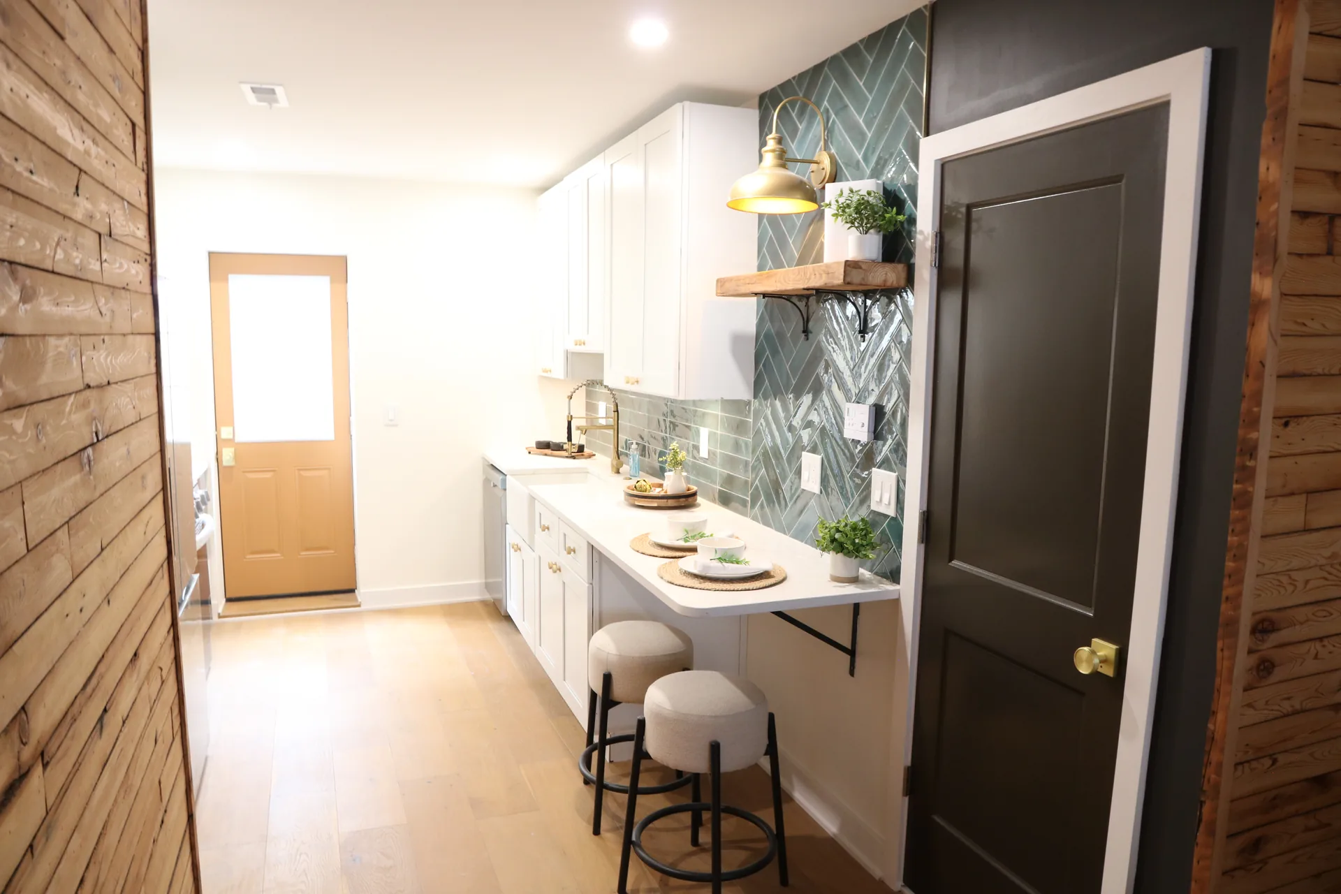 Galley kitchen remodel with white cabinets, quartz counters, and warm wood accents