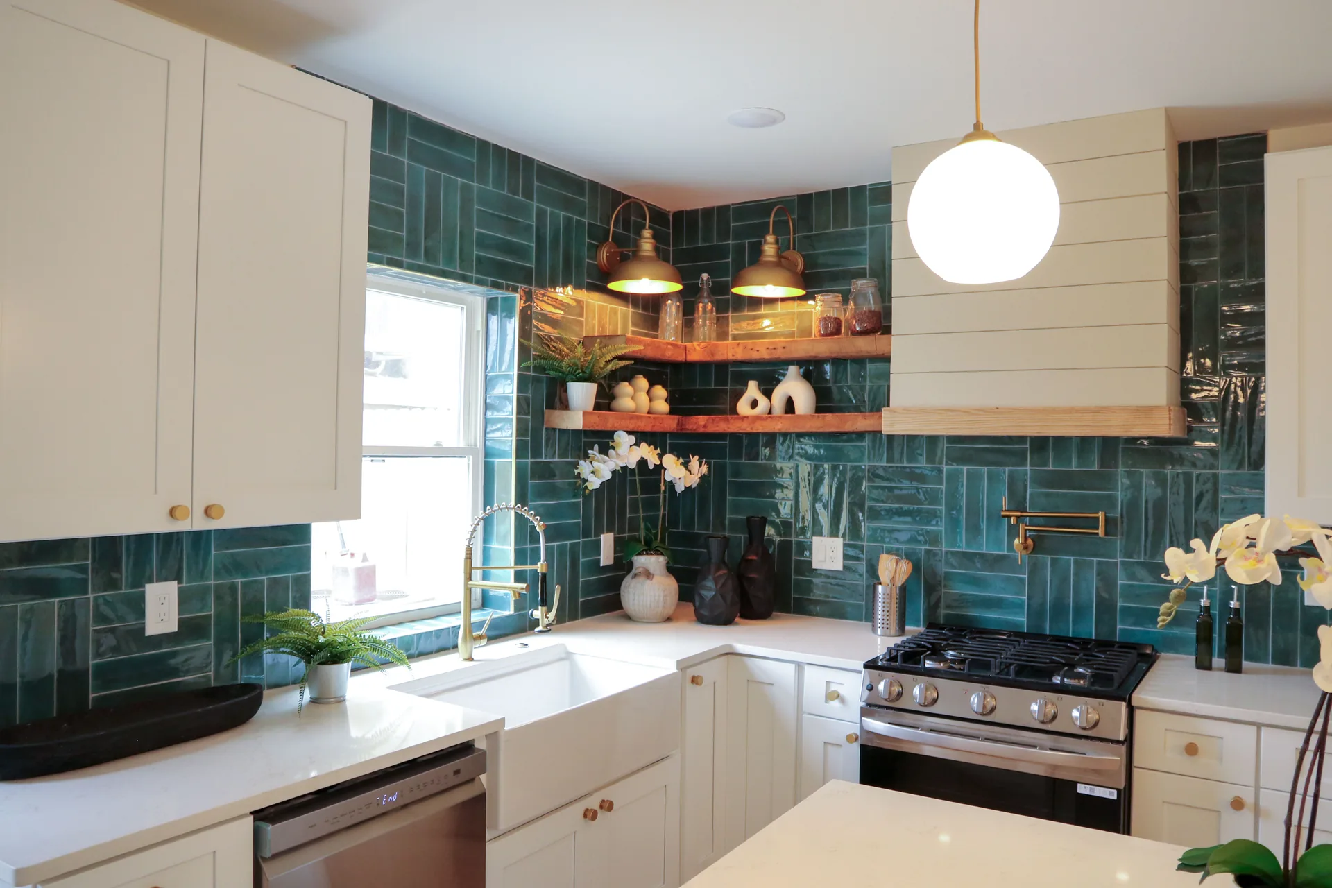 Kitchen window with farmhouse sink and deep teal tile backsplash