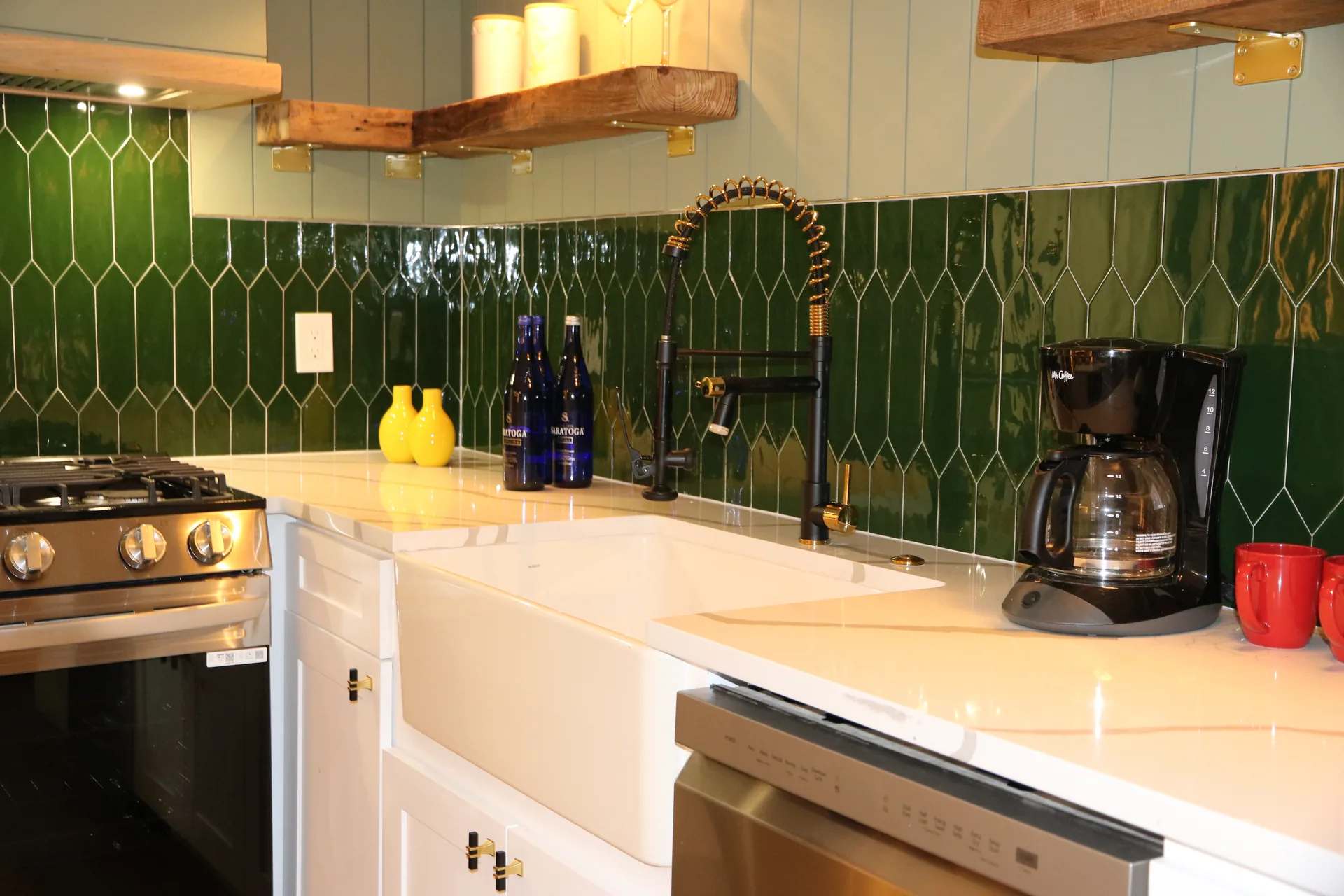 Farmhouse sink kitchen with emerald green picket-tile backsplash and quartz counters