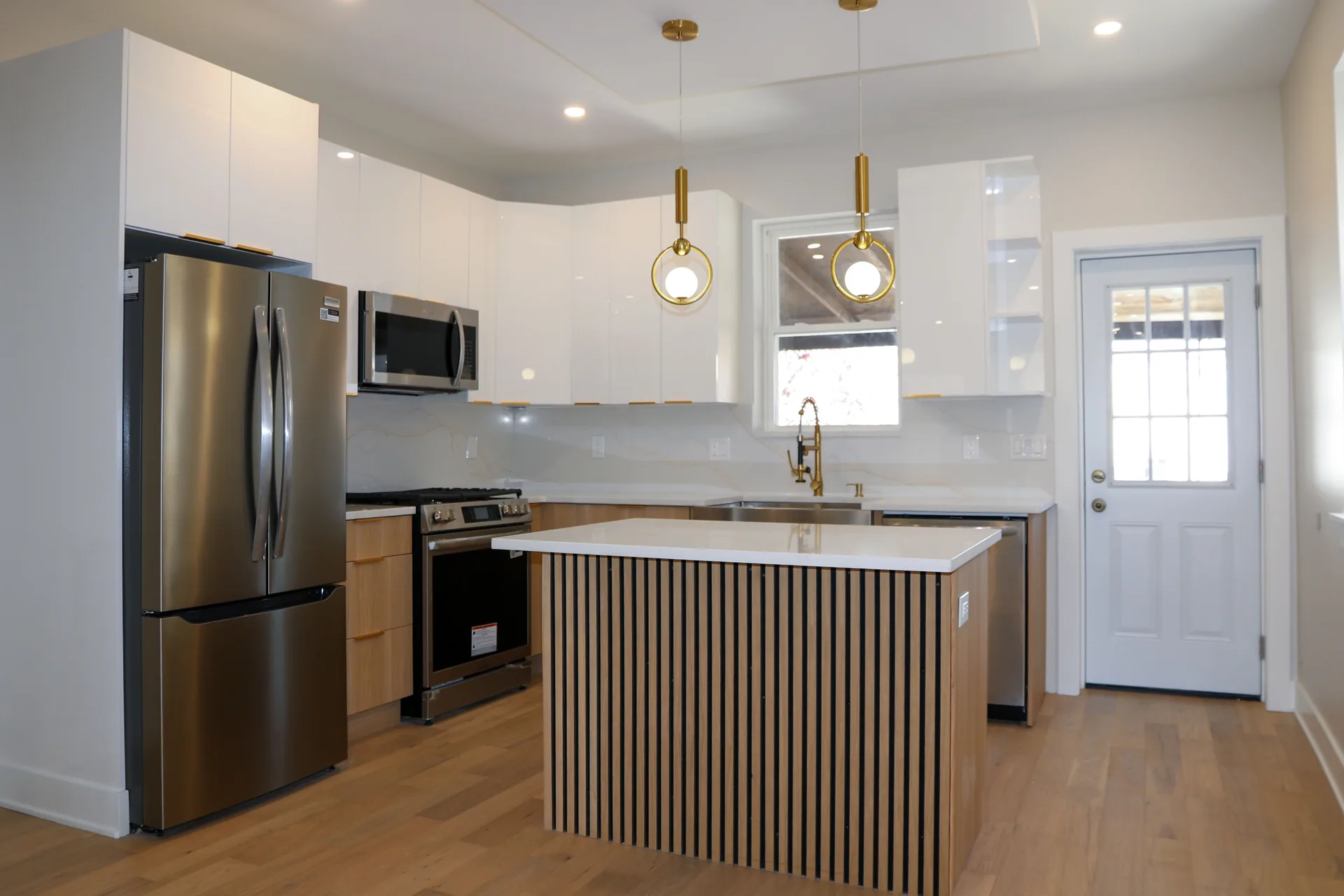 Modern white slab-door kitchen with slat island and recessed ceiling detail