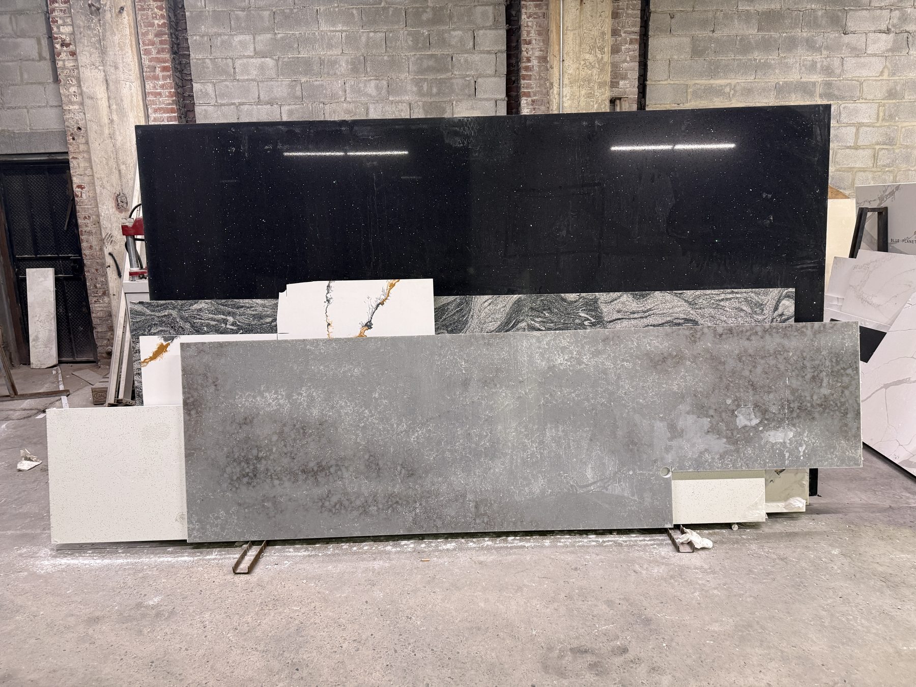 Black granite and gray quartz slabs displayed side by side